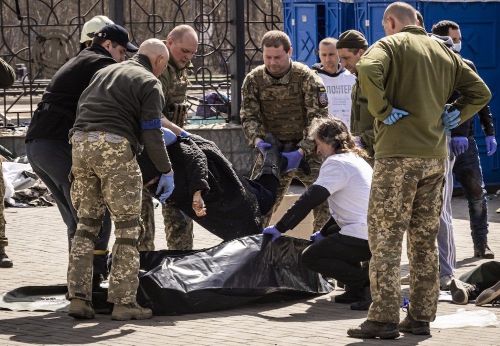 Ukrainian soldiers clear out bodies after a rocket attack killed at least 35 people on April 8, 2022 at a train station in Kramatorsk, eastern Ukraine, that was being used for civilian evacuations. u00e2u20acu201d AFP pic