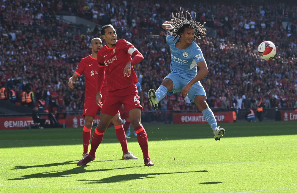 Manchester City defender Nathan Ake heads the ball next to Liverpool defender Virgil van Dijk during the English FA Cup semi-final match at Wembley Stadium in north west London, April 16, 2022. u00e2u20acu201d AFPnn