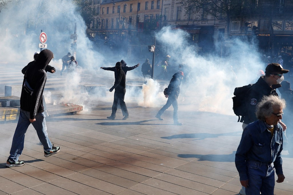 Protestors walk through tear gas during a demonstration against u00e2u20acu02dcracism and fascismu00e2u20acu2122 in Paris on April 16, 2022. u00e2u20acu201d AFP pic