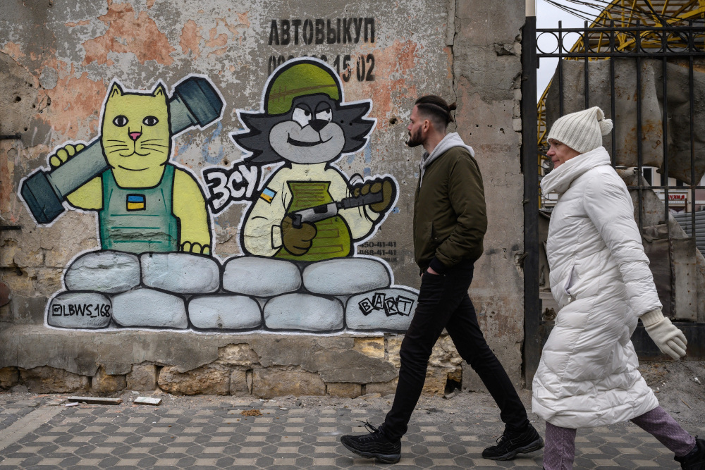 Pedestrians walk in front of a street art creation by the LBWS street art collective on a street in the port city of Odessa. u00e2u20acu201d AFP pic