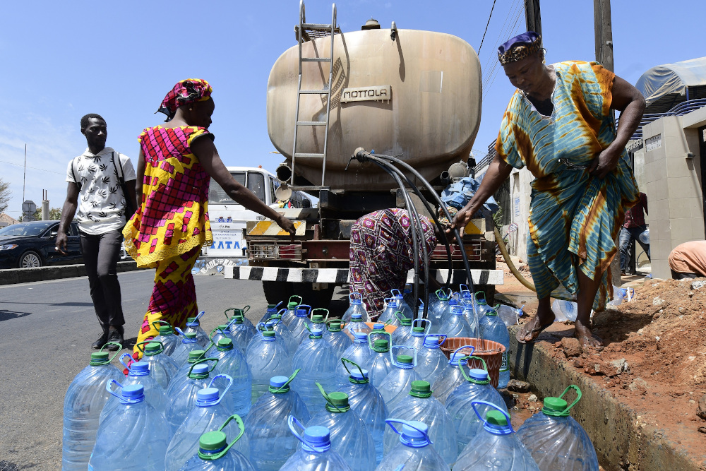 Senegalese women fill water bottles from a tanker truck during a public distribution in Dakar. u00e2u20acu201d AFP pic
