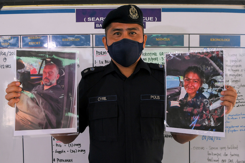 Mersing police chief Supt Cyril Edward Nuing shows photos of two divers Adrian Peter Chesters (left) and Alexia Alexandra Molina (right) who were rescued at a location south of Pengerang, near Kota Tinggi April 9, 2022. u00e2u20acu201d Bernama pic