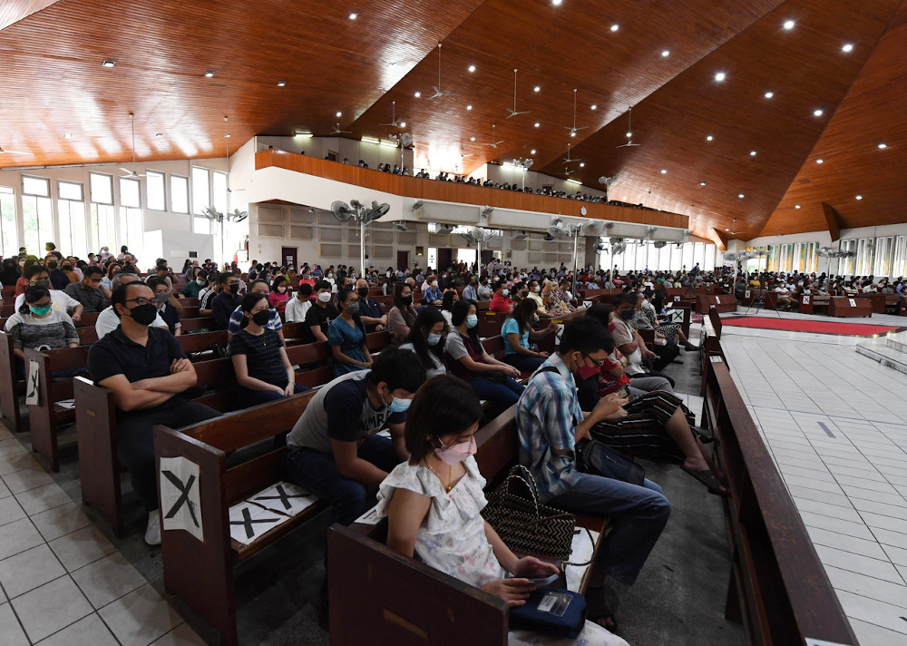 Christians attend mass at the Sacred Heart Cathedral in Kota Kinabalu with further relaxation of the standard operating procedures (SOP) April 3, 2022. — Bernama pic