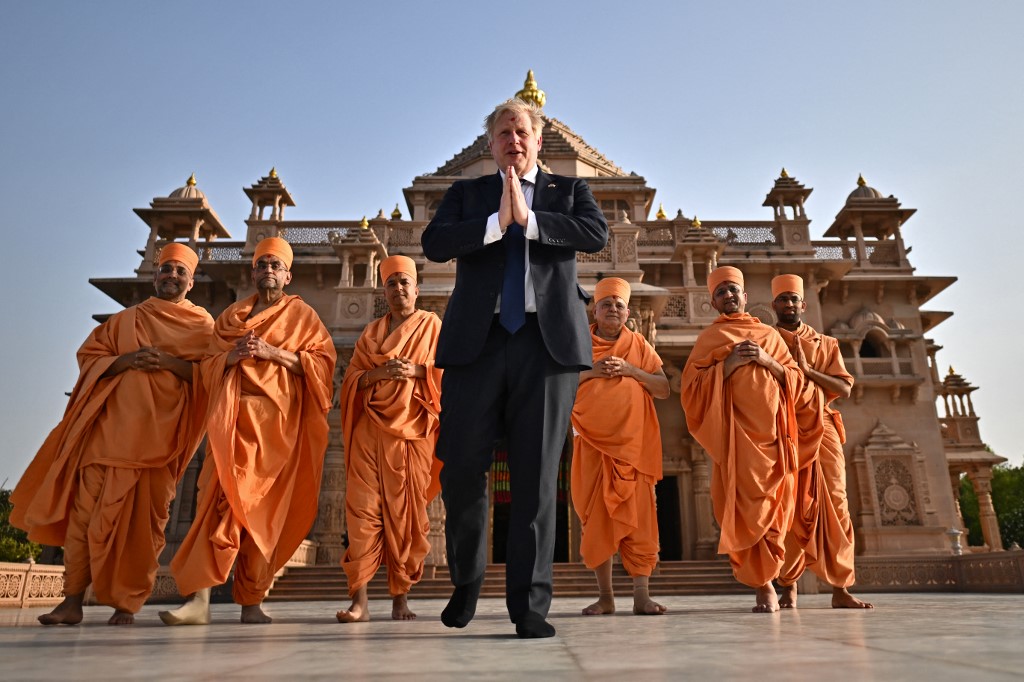 Britainu00e2u20acu2122s Prime Minister Boris Johnson (centre) poses with sadhus or Hindu holymen in front of the Swaminarayan Akshardham temple in Gandhinagar on April 21, 2022. u00e2u20acu201d AFP pic