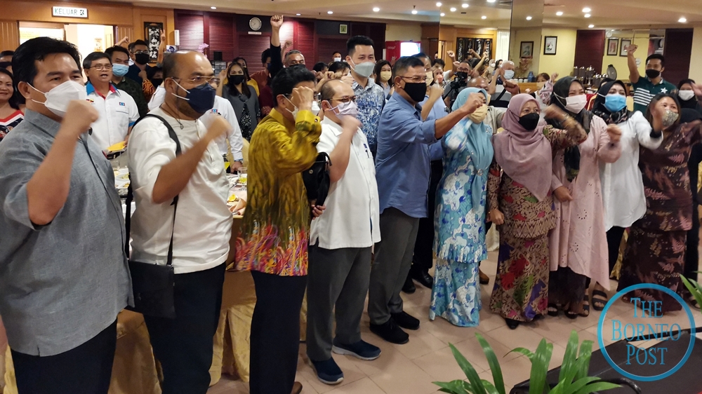 Saifuddin (fifth, left) and his comrades during the campaign rally cum breaking of fast at a hotel in Miri yesterday. u00e2u20acu2022 Borneo Post pic