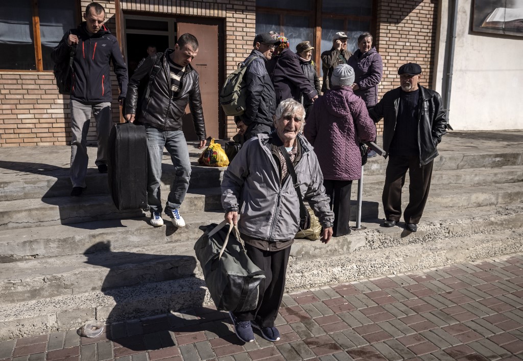 People wait for a bus with their luggage a day after a rocket attack at a train station in Kramatorsk, on April 9, 2022. u00e2u20acu201d AFP pic