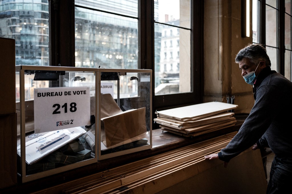City Hall employee prepares a polling station in Lyon, on April 9, 2022, on the eve of the French presidential election's first round. French voters head to the polls on April 10 and 24 for a two-round presidential election. u00e2u20acu201d AFP pic