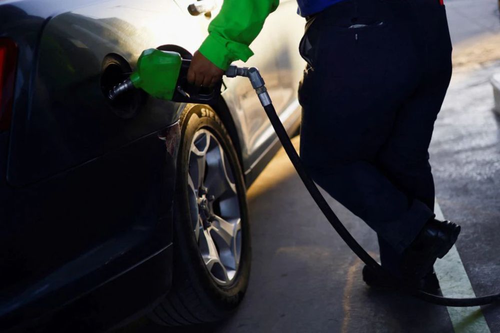 A worker fills a car belonging to a Texas resident, with gasoline at a gas station following increased fuel prices in US, in Ciudad Juarez, Mexico March 14, 2022. u00e2u20acu201d Reuters pic