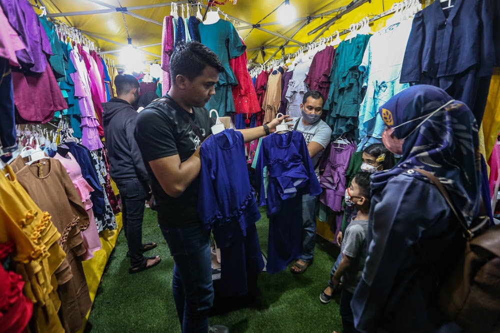 Trader Muhammad Hapis Mohd Syafarudin says he can finally breathe a sigh of relief this year, after restrictions such as crowd limits and travel bans put a damper on the Aidilfitri celebrations from 2020. ― Picture by Hari Anggara