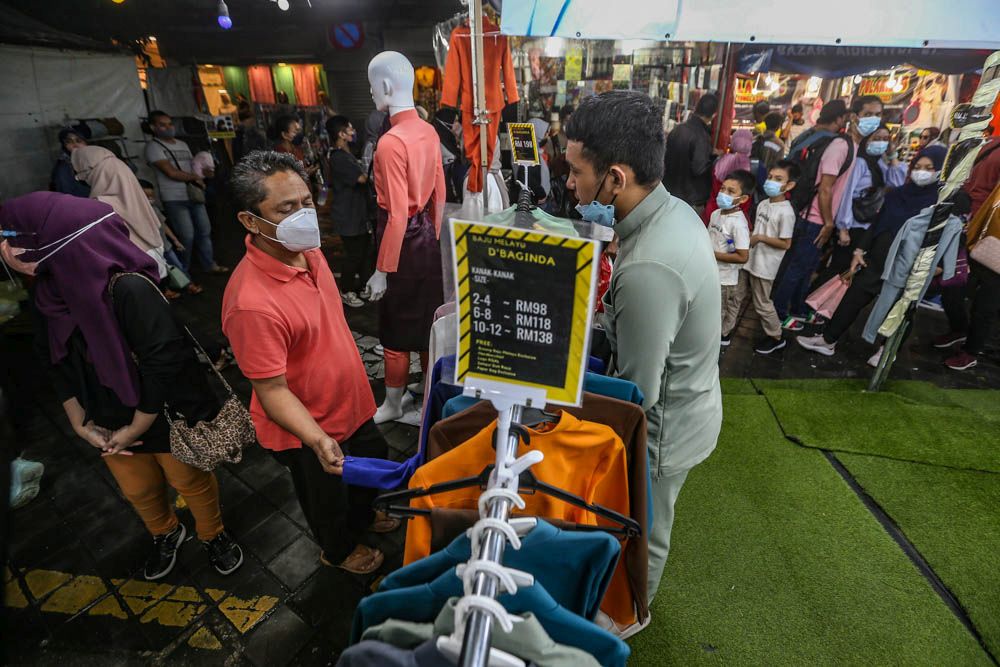 People visit the Aidilfitri Bazaar on Jalan Tuanku Abdul Rahman, Kuala Lumpur April 27, 2022. — Picture by Hari Anggara