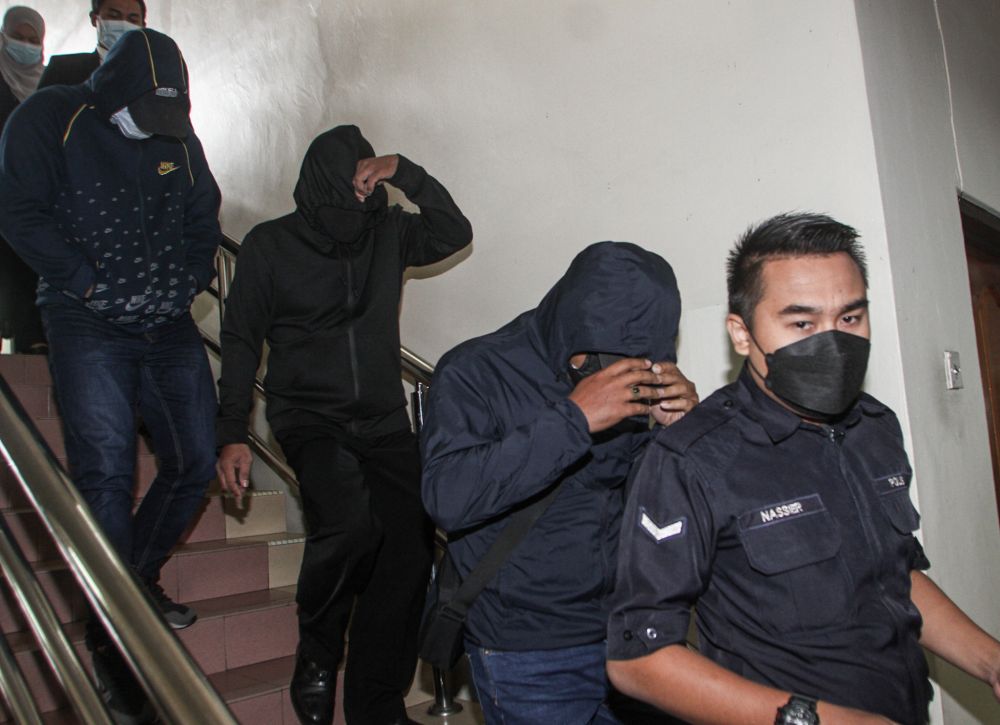 Road Transport Department enforcement personnel Mohamad Fadzli Robaini, Sazali Rani, and Khairumin Sahdan were fined RM5,000 each for graft at the Ipoh Sessions Court April 28, 2022. u00e2u20acu201d Picture by Farhan Najib
