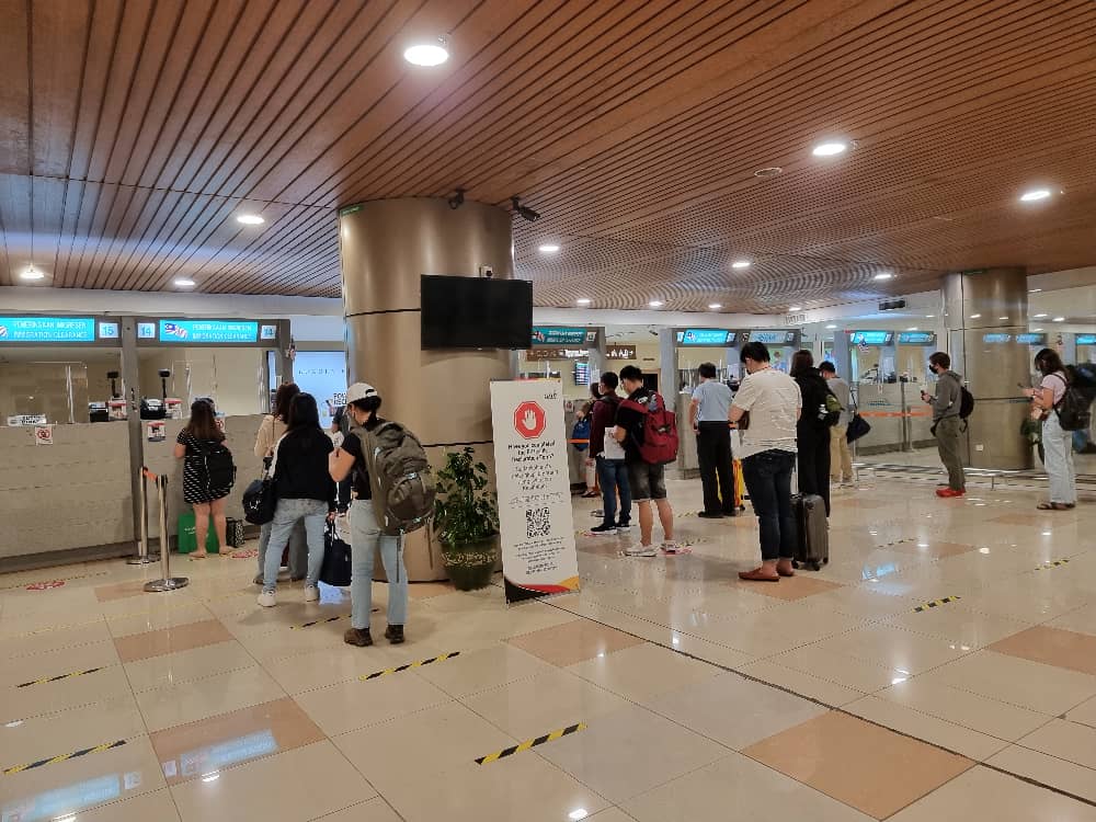 Passengers lining up at the Immigration counters upon their arrival at Kuching International Airport (KIA). — Borneo Post Online pic