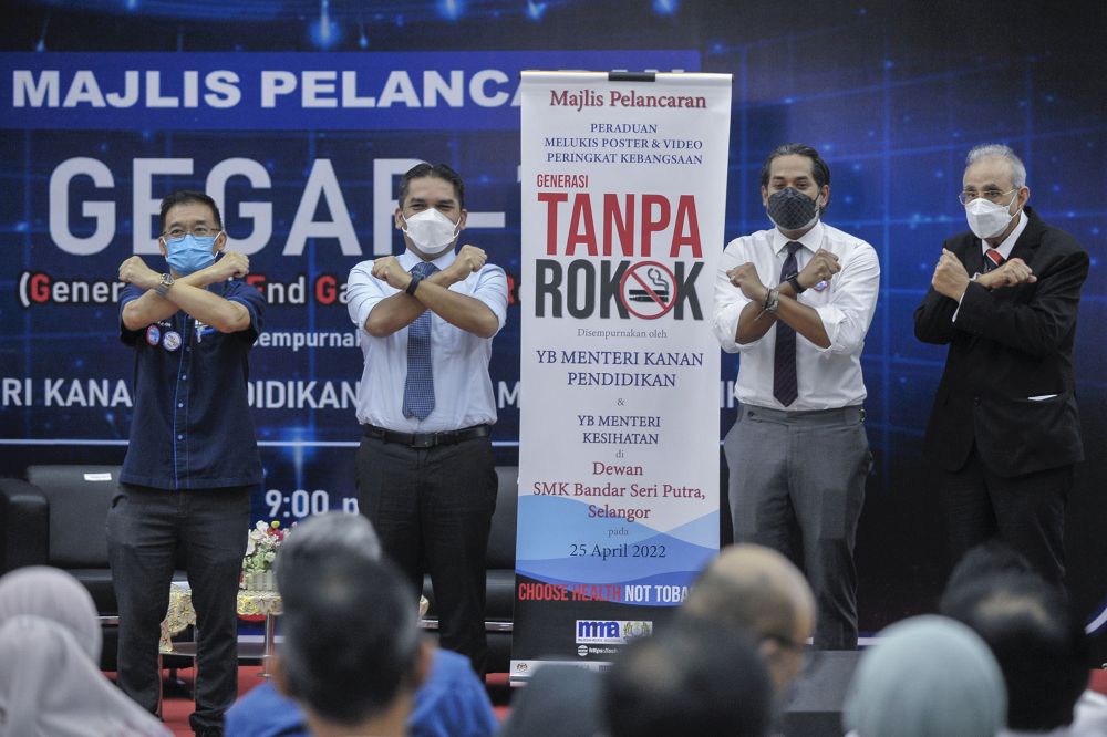 Health Minister Khairy Jamaluddin and Education Minister Datuk Radzi Jidin pose for the cameras during the launch of an anti-smoking programme at Sekolah Menengah Kebangsaan Bandar Seri Putra, Kajang April 25, 2022. u00e2u20acu201d Picture by Shafwan Zaidonnn