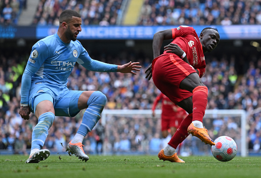 Liverpool striker Sadio Mane turns away from Manchester City defender Kyle Walker at the Etihad Stadium in Manchester, north-west England, April 10, 2022. u00e2u20acu201d AFP picnn
