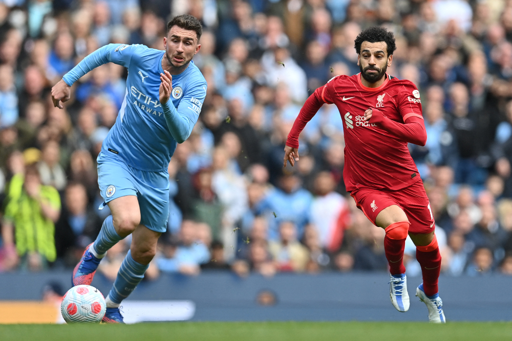 Liverpool midfielder Mohamed Salah vies with Manchester City defender Aymeric Laporte at the Etihad Stadium in Manchester, north-west England, April 10, 2022. u00e2u20acu201d AFP pic 