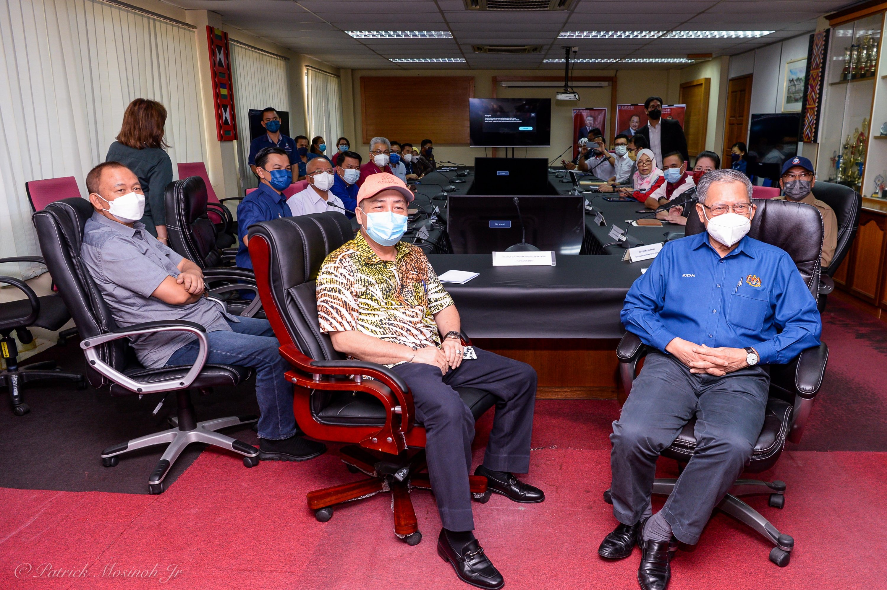 Hajiji (left) with Mustapha before the start of the BMTKM Penimbawan briefing at the Tuaran District Office today. u00e2u20acu2022 Borneo Post pic