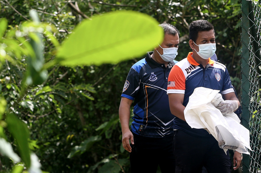 Police carry the remains of a five-year-old girl found in a bush in Taman Bukit Zamrud in Negri Sembilan, April 7, 2022. u00e2u20acu201d Bernama pic 