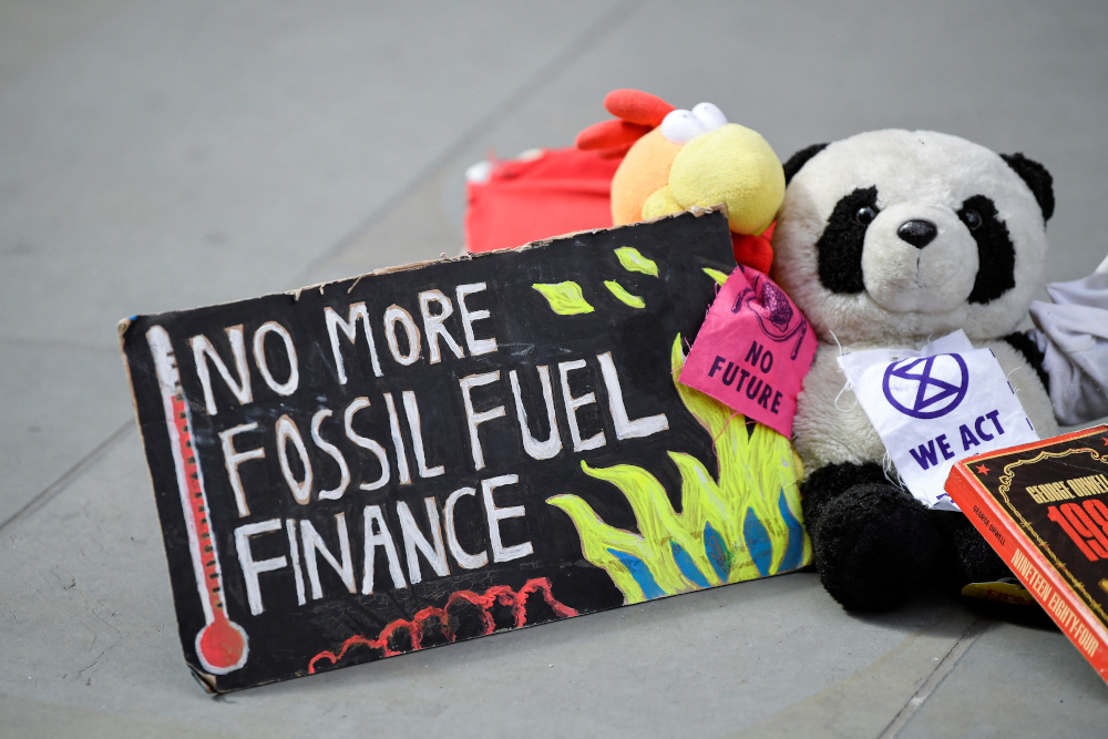 A sign lies on the ground as members of Extinction Rebellion stage a protest against the use of and investment in fossil fuel, outside offices of Vanguard Asset Management on Earth Day in the City of London April 22, 2022. u00e2u20acu201d Reuters pic