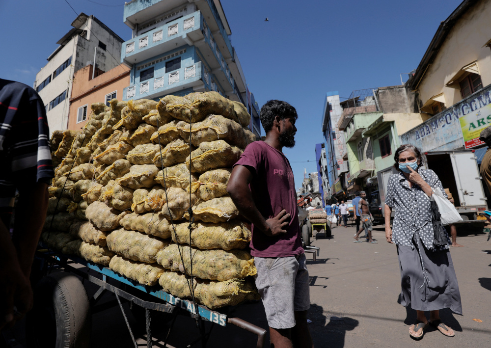 A man stands by a cart with potatoes at a market, amid the countryu00e2u20acu2122s economic crisis in Colombo, Sri Lanka, April 7, 2022. u00e2u20acu201d Reuters pic