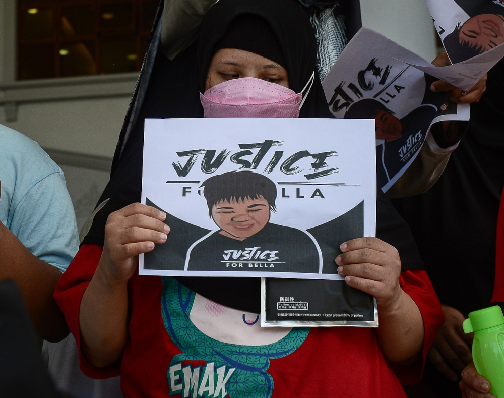 A child from the Down Syndrome Association of Malaysia holds a sign saying u00e2u20acu02dcJustice for Bellau00e2u20acu2122 at the Kuala Lumpur Court Complex, April 1, 2022. u00e2u20acu201d Bernama pic 