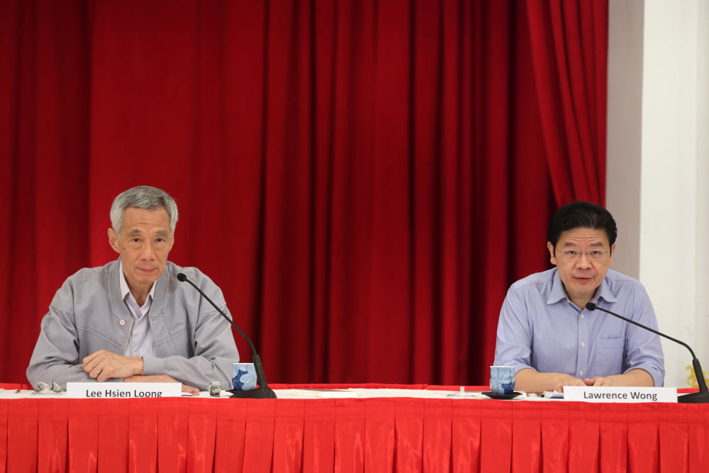Prime Minister Lee Hsien Loong (left) and Finance Minister Lawrence Wong speaking at a press conference on leadership succession on April 16, 2022. u00e2u20acu201d Picture courtesy of Singaporeu00e2u20acu2122s Ministry of Communications and Information
