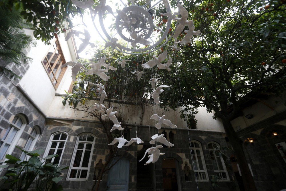 An art installation using ceramic doves is pictured inside a courtyard in old Damascus, as part of an exhibition titled u00e2u20acu02dcOnce Upon a Timeu00e2u20acu00a6 Windowsu00e2u20acu2122, in the Syrian capital. u00e2u20acu201d AFP pic