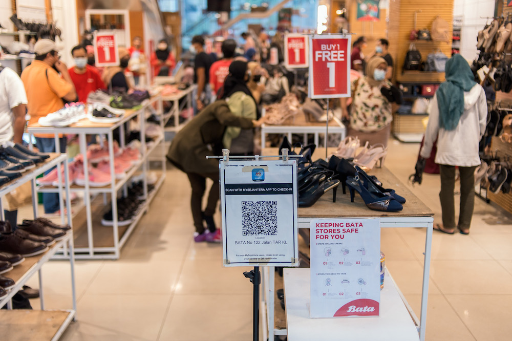 Malaysians no longer need to scan the MySejahtera contact tracing app to enter premises starting May 1. — Picture by Shafwan Zaidon