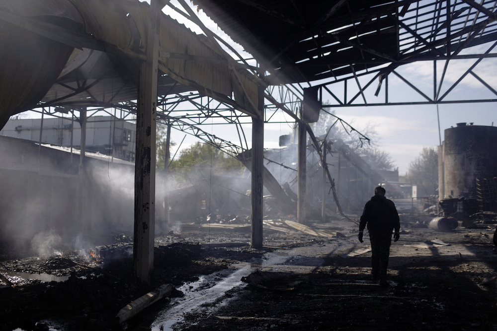 A man walks at a damaged area inside a burning plant, following Russian shelling amid Russia's attack on Ukraine, in Kharkiv, Ukraine April 30, 2022. u00e2u20acu201d Reuters pic