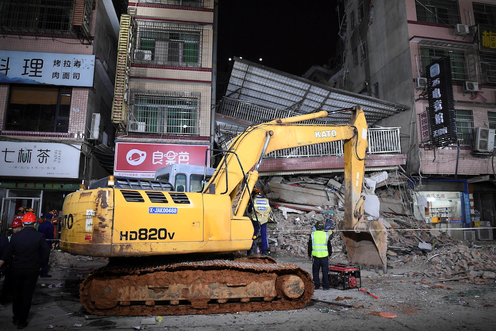 Rescuers work next to an excavator at a site where a building collapsed in Changsha, Hunan province, China April 29, 2022. u00e2u20acu201d cnsphoto via Reuters