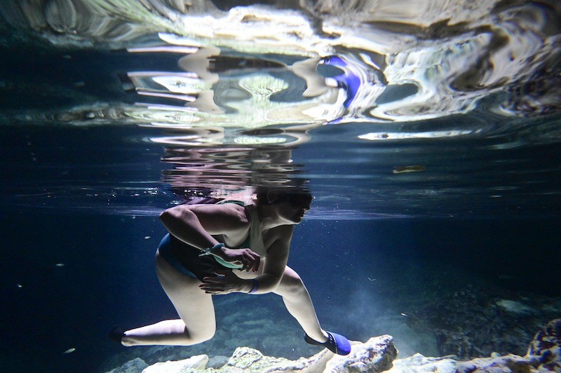 A tourist swims in a water-filled sinkhole known as cenote at Aktun Chen natural park in Akumal, Tulum, Quintana Roo State, Mexico April 27, 2022. u00e2u20acu201d AFP pic