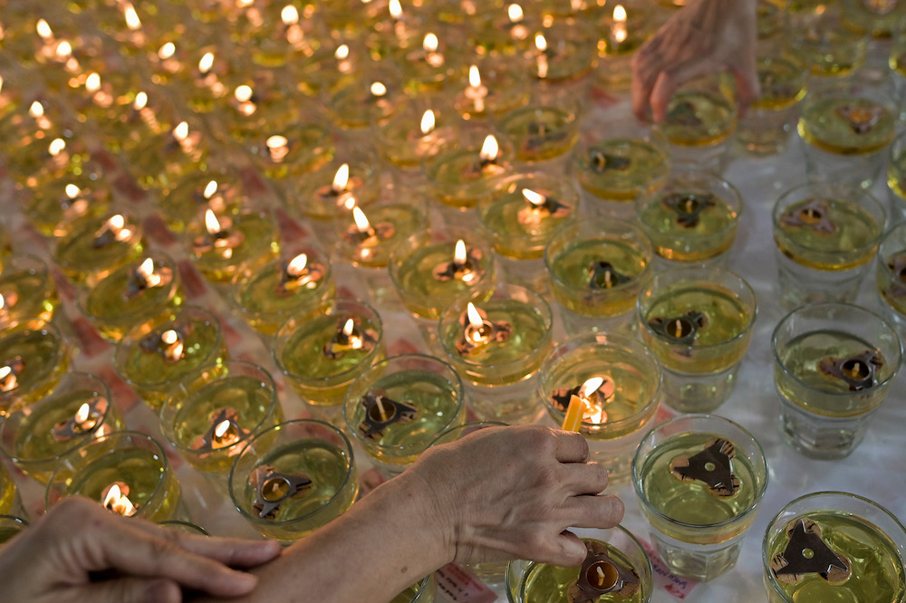 Devotees light candles on Wesak Day at the Maha Vihara temple in Brickfields May 15,2022. — Picture by Miera Zulyana
