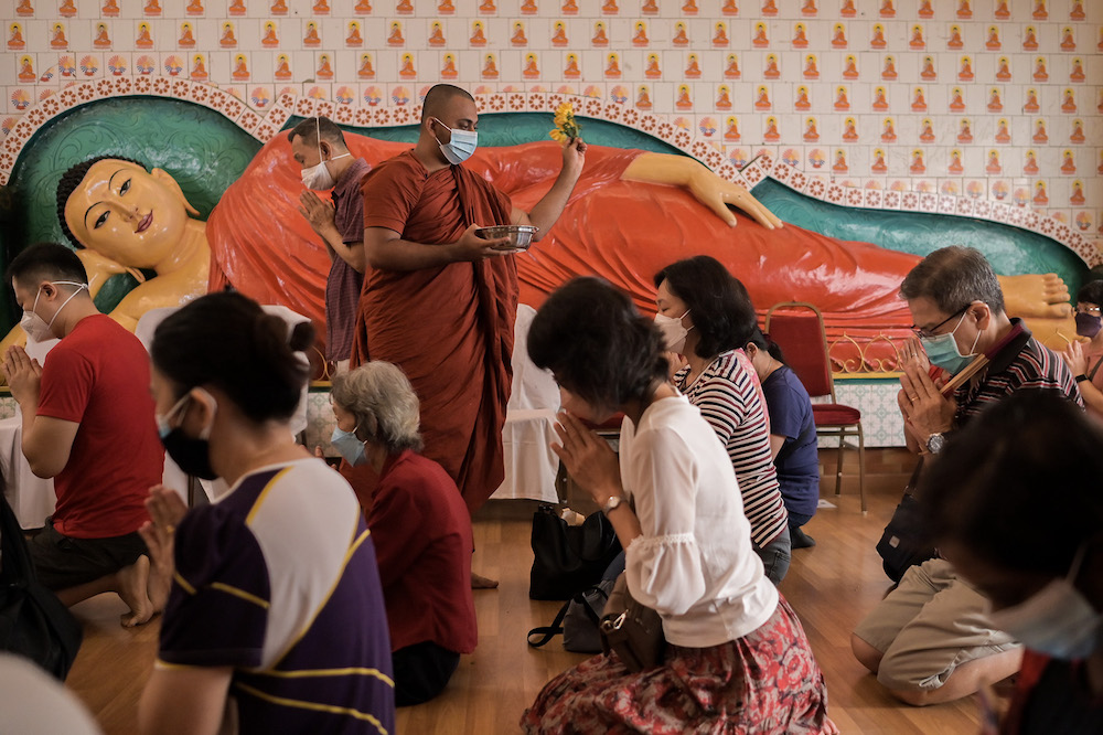 Buddhist devotees perform prayers on Wesak Day at the Maha Vihara temple in Brickfields May 15,2022. u00e2u20acu201d Picture by Miera Zulyana