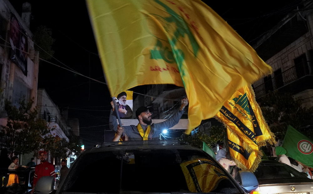 Supporters of Lebanon's Hezbollah leader Sayyed Hassan Nasrallah carry flags while riding in a convoy as votes are being counted in Lebanon's parliamentary election, in Nabatiyeh, southern Lebanon May 15, 2022. u00e2u20acu201d Reuters pic