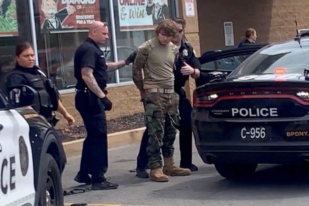 A man is detained following a mass shooting in the parking lot of TOPS supermarket, in a still image from a social media video in Buffalo, New YorkMay 14, 2022. u00e2u20acu201d Courtesy of BigDawg via Reuters
