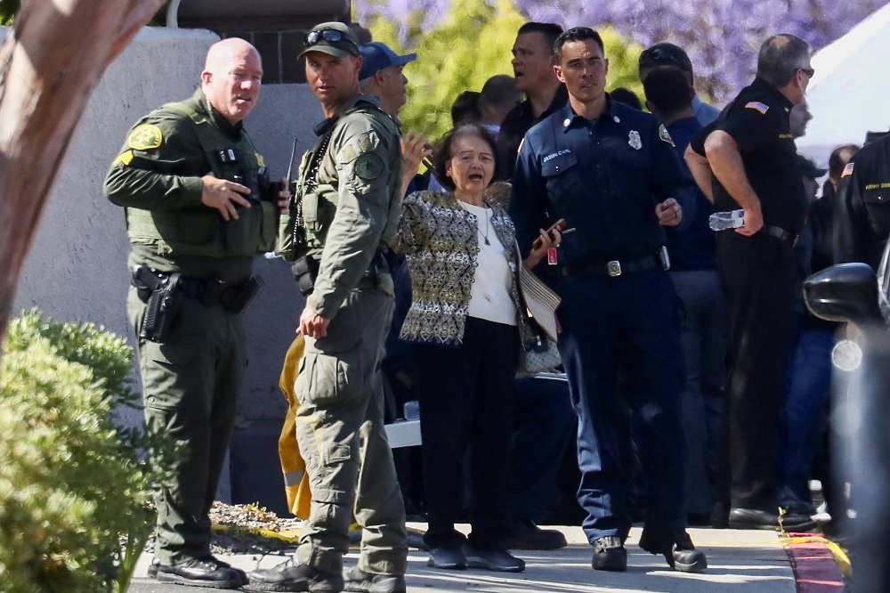 A woman reacts next to law enforcement officers after a deadly gunfire erupted at Geneva Presbyterian Church in Laguna Woods, California May 15, 2022. u00e2u20acu201d Reuters pic