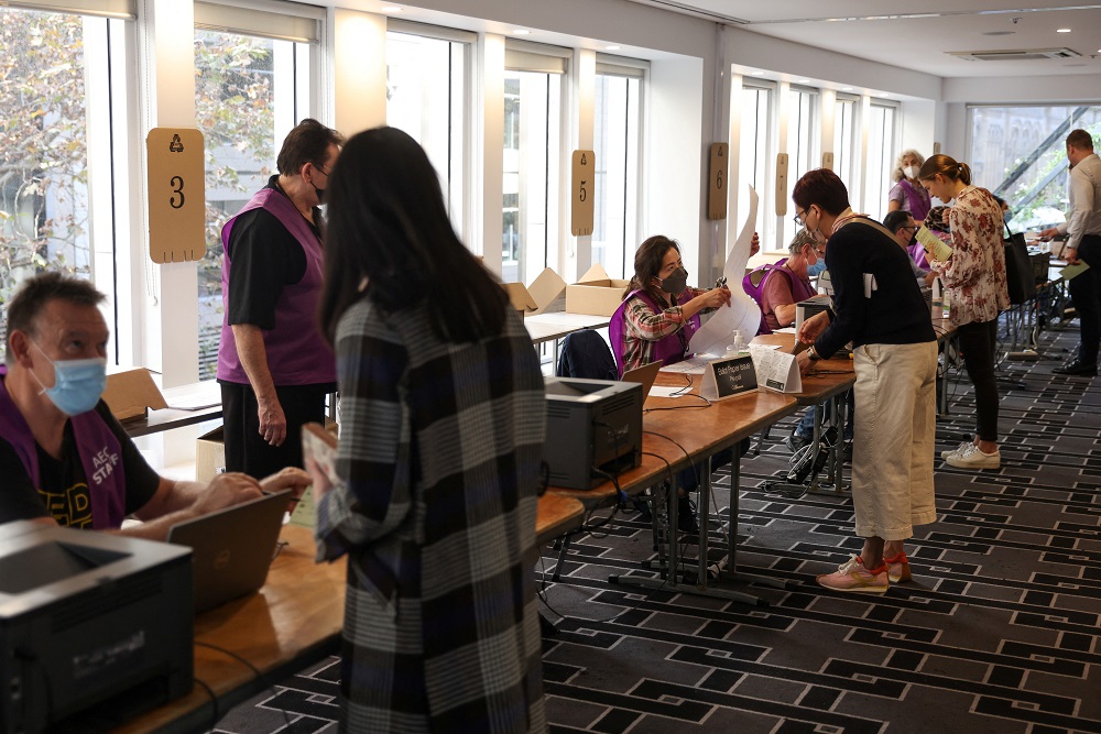 Staff members assist voters arriving to cast their ballots ahead of the national election at an Australian Electoral Commission early voting centre, in the Central Business District of Sydney May 17, 2022. u00e2u20acu201d Reuters pic