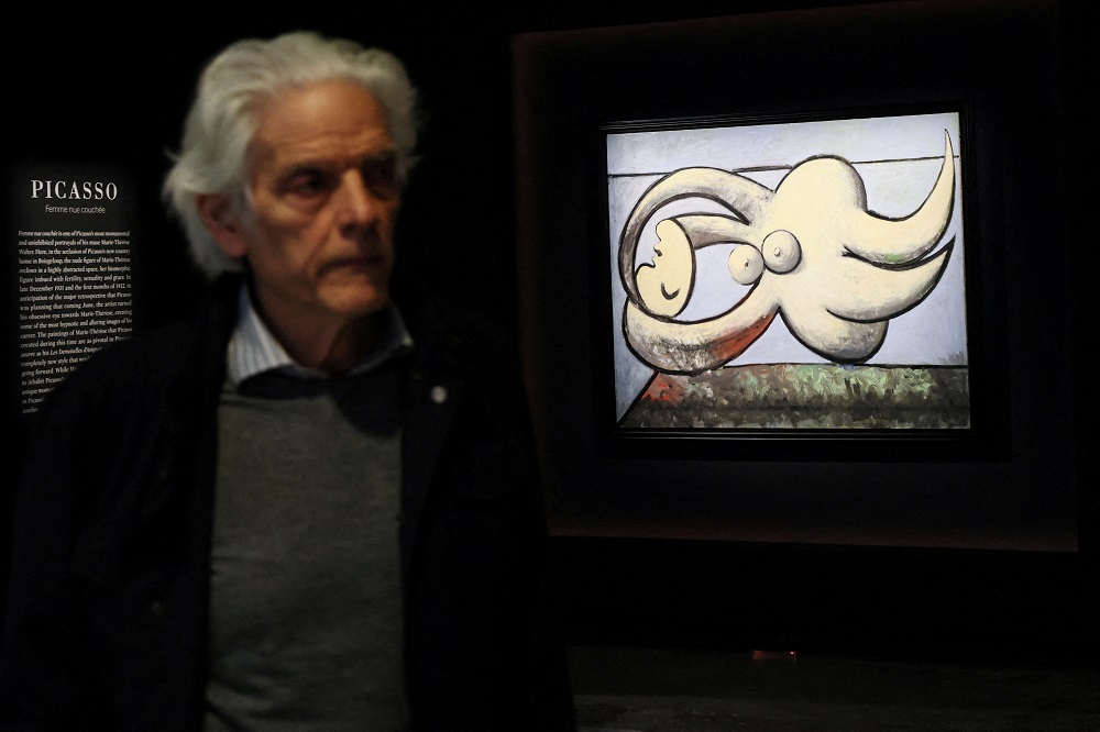 A man walks past artwork titled u00e2u20acu02dcFemme nue coucheeu00e2u20acu2122, by Pablo Picasso during a media preview for Sothebyu00e2u20acu2122s spring contemporary and modern art sales auction in New York May 6, 2022. u00e2u20acu201d Reuters pic