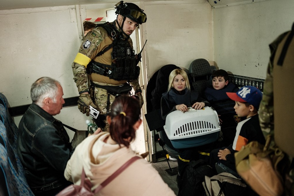A police officer checks families waiting in an armoured vehicle before being evacuated in Lysychansk, eastern Ukraine May 15, 2022, amid the Russian invasion of Ukraine. u00e2u20acu201d AFP pic