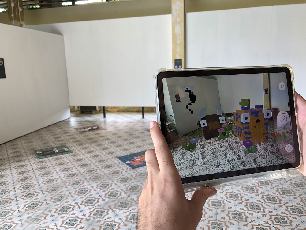 The bulls and sunbear toys in pixel art by Drawdelow viewed using the Perk Reality app at the Augmented Reality Toy exhibition. u00e2u20acu201d Picture by Opalyn Mok
