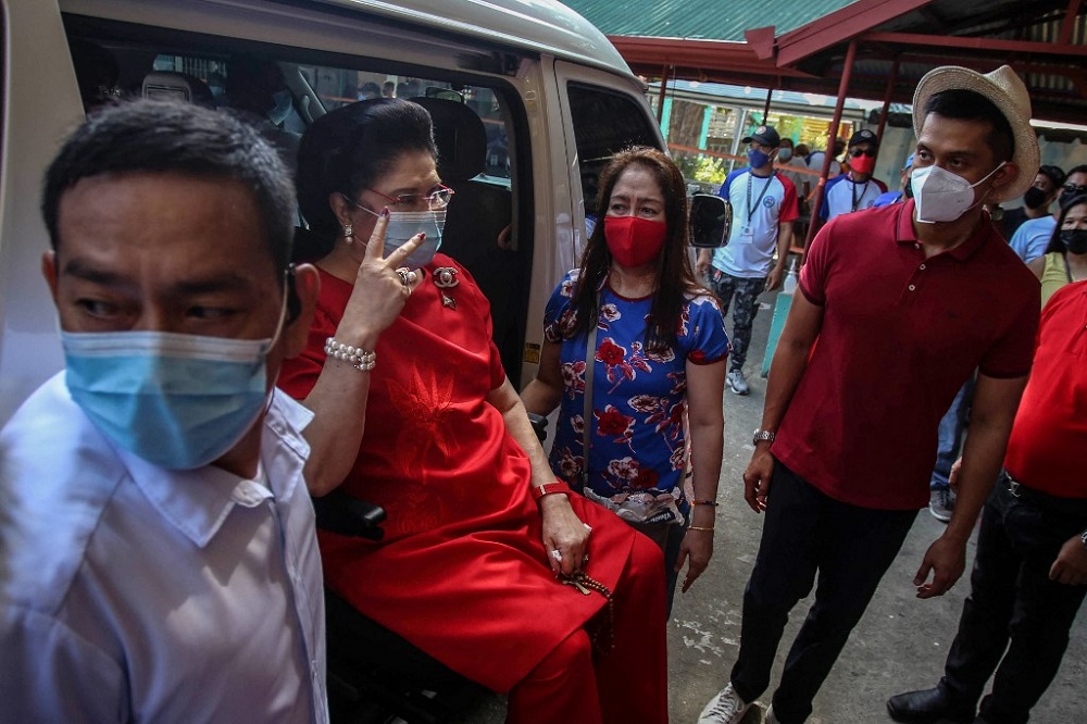 Imelda Marcos (second left), the mother of Philippine presidential candidate Ferdinand Marcos Jr, gestures during the presidential election at Mariano Marcos Memorial Elementary School in Batac, Ilocos Norte May 9, 2022. u00e2u20acu201d AFP pic