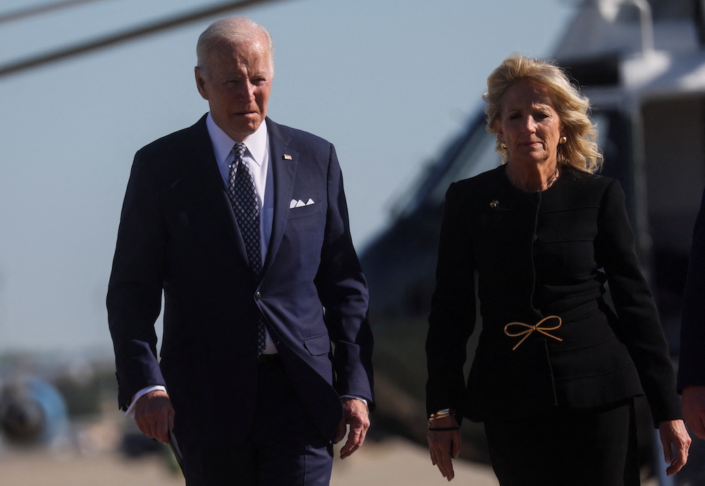 US  President Joe Biden walks with first lady Jill Biden  as they depart Washington on travel to Buffalo, New York to meet with families and victims in the wake of a weekend shooting at a Buffalo supermarket, at Joint Base Andrews in Maryland, U.S., May 1