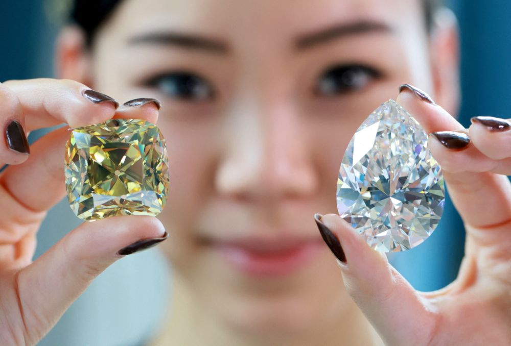 The u00e2u20acu02dcRed Crossu00e2u20acu2122, a fancy intense yellow, cushion-shaped 205.07 carat diamond and a 228.31 carat white diamond called u00e2u20acu02dcThe Rocku00e2u20acu2122 are pictured during a preview at Christieu00e2u20acu2122s before their auction sale in Geneva, May 6, 2022. u00e2u20acu201d Reuter pic