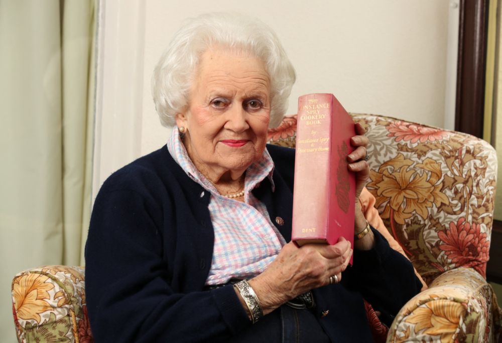 Angela Wood holds a copy of the original cook book, u00e2u20acu02dcThe Constance Spry Cookery Booku00e2u20acu2122, where her recipe appeared as she poses for a photograph at her home in Kimbolton, north of London. u00e2u20acu201d AFP pic