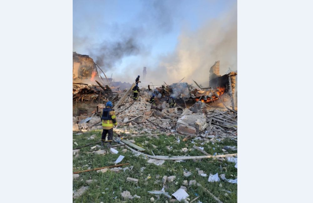 Emergency crew tend to a fire near a burning debris, after a school building was hit as a result of shelling, in the village of Bilohorivka, Luhansk, Ukraine, May 8, 2022. u00e2u20acu201d State Emergency Services/Handout via Reuters