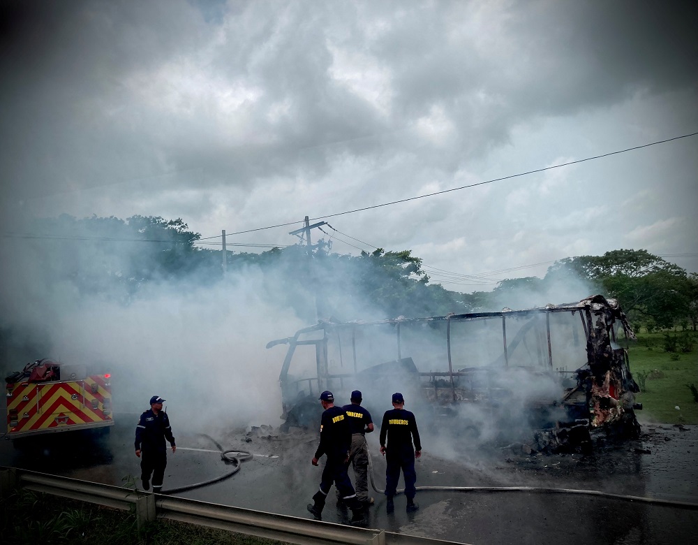 Colombian firefighters stand by a burnt vehicle, after 'Clan del Golfo', a neo-paramilitary group and cartel ordered a four-day terror campaign in Bolivar, Colombia May 5, 2022 in this picture obtained from social media. u00e2u20acu2022 Handout via Reuters