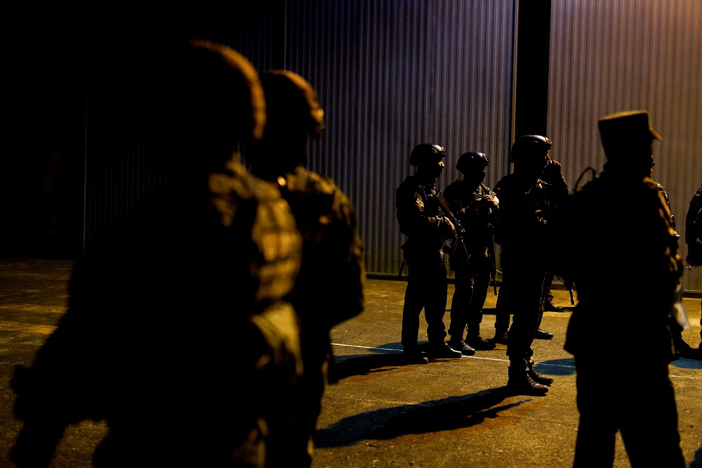 Police officers stand together after a helicopter picked up inmates accused of being the leaders of a prison riot where dozens of inmates were killed before it was put out by authorities, in Santo Domingo, Ecuador May 9, 2022. u00e2u20acu2022 Reuters pic