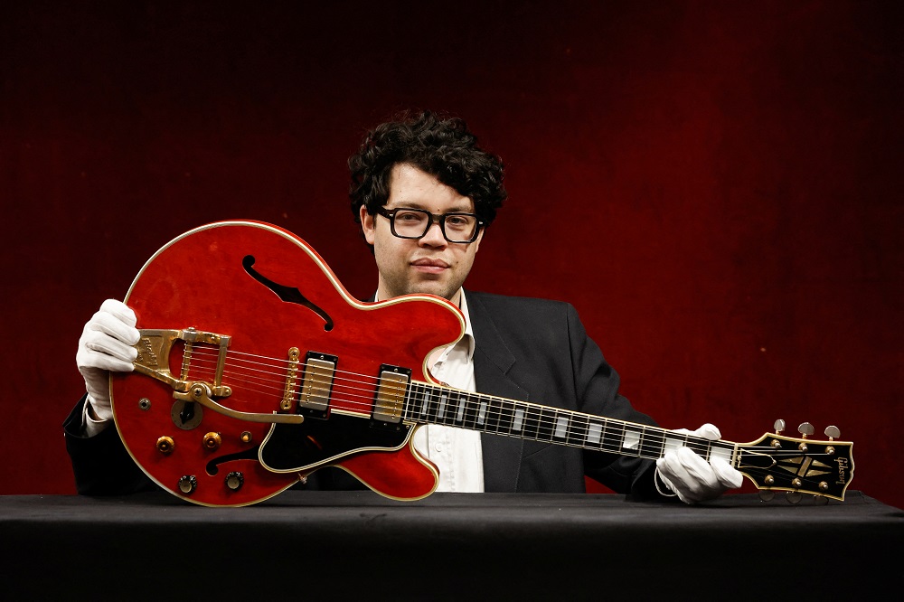 Guitar expert Arthur Perrault holds the Oasis band member Noel Gallagher's Gibson ES-355 guitar, destroyed during an argument with his brother at Paris' Rock en Seine festival in 2009, at a media preview in Paris, France May 13, 2022. u00e2u20acu2022 Reuters pic