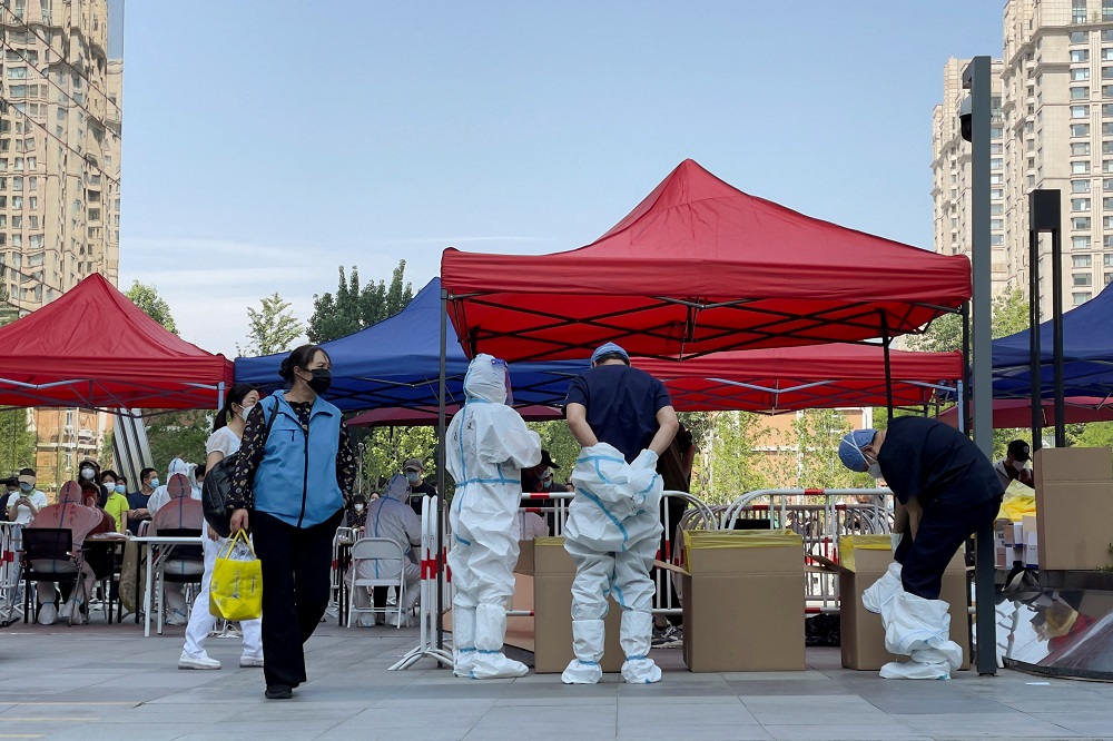 Workers remove their protective suits at a makeshift nucleic acid testing site during a Covid-19 mass testing in Chaoyang district of Beijing, China May 3, 2022. u00e2u20acu2022 Reuters pic 
