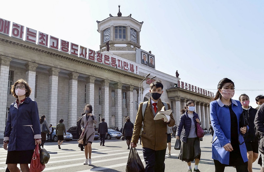 People wearing protective face masks walk in front of Pyongyang Station in Pyongyang, North Korea April 27, 2020, in this photo released by Kyodo. u00e2u20acu2022 Kyodo via Reuters