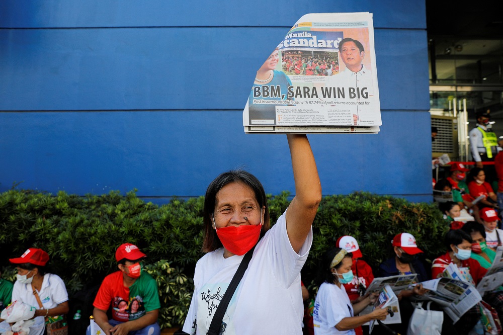 A supporter of presidential candidate Ferdinand u00e2u20acu02dcBongbongu00e2u20acu2122 Marcos Jr. holds up a newspaper with the winning of Marcos Jr. on the headline at the candidate's headquarters in Mandaluyong City, Philippines May 10, 2022. u00e2u20acu2022 Reuters pic